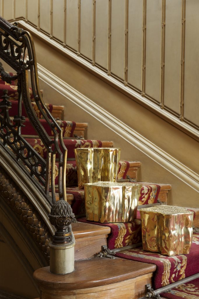 Intimate Luxury: Golden SideTables on the stairs.