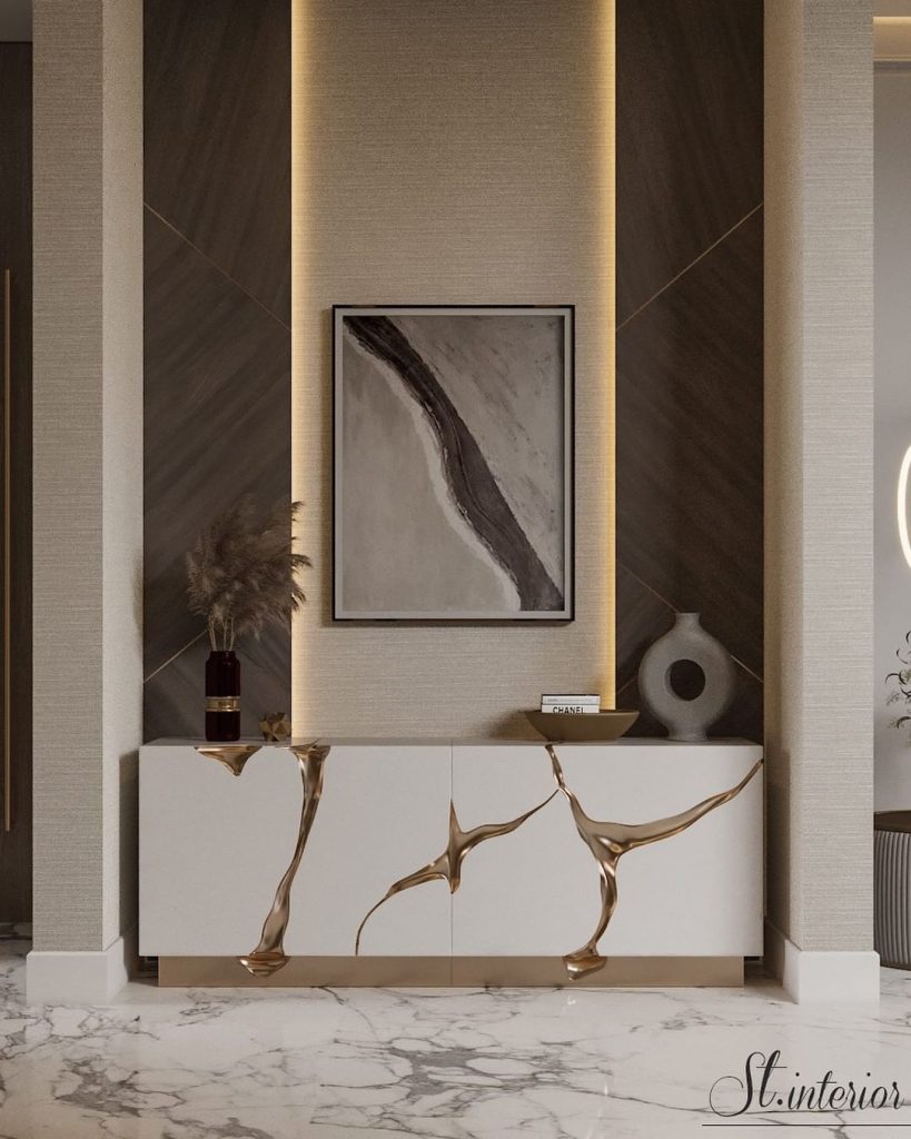 entryway in neutral colors with a white and gold sideboard