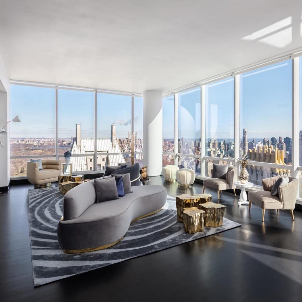 Luxury Living Room Sets - A living room full of statement pieces, from center tables in gold to a different sofa shape in grey color and gold details