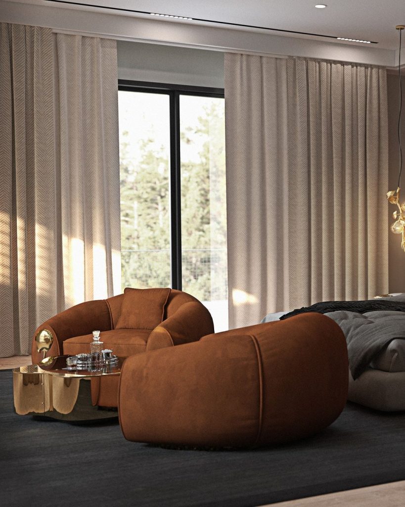 brown armchairs and gold center table in a master bedroom