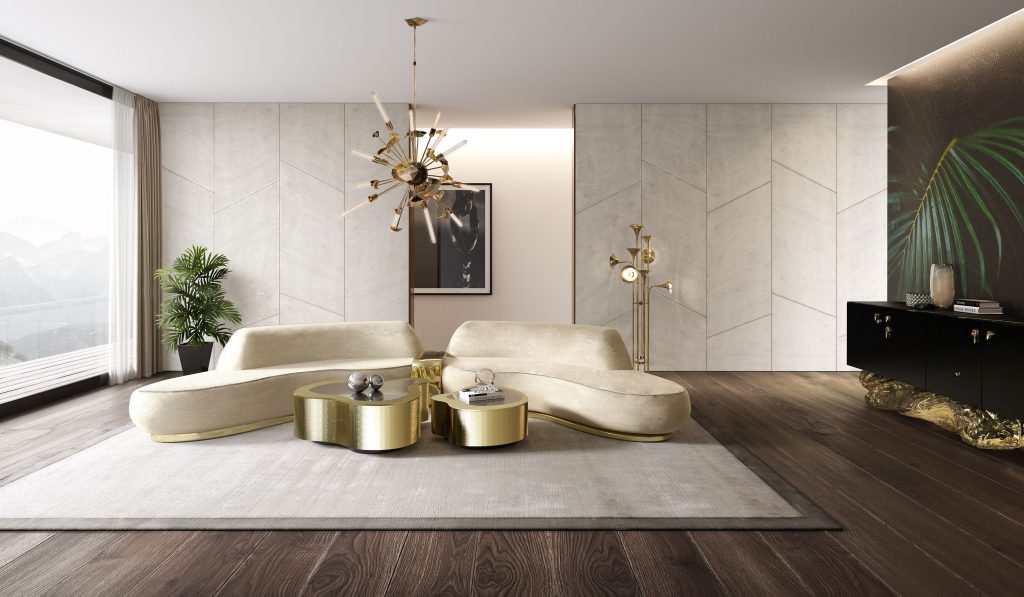 luxury living room with beige sofa, gold curvy center table and a black and gold sideboard