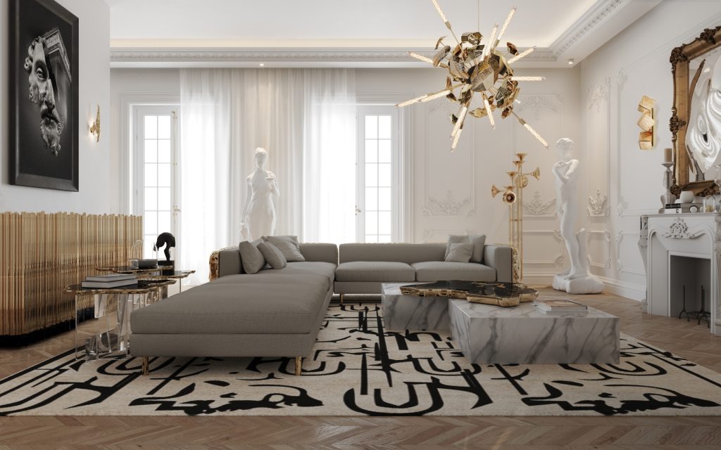 Luxury Living Room Sets - A New York living room with a modular sofa with gold detailed back, a marble center table, a gold sideboard and a chandelier.