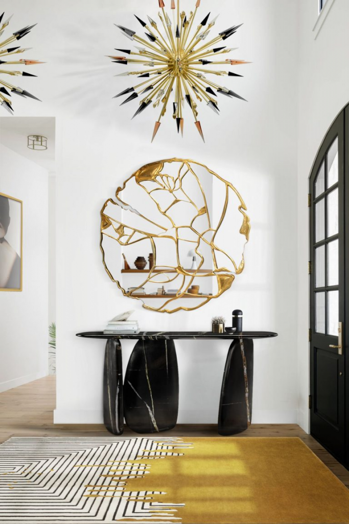 luxury entryway with black marble console, one big mirror and a black and yellow rug.